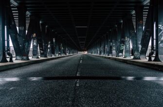 black asphalt road under bridge