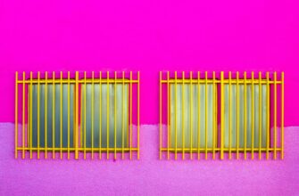 symmetric windows with grids on pink wall